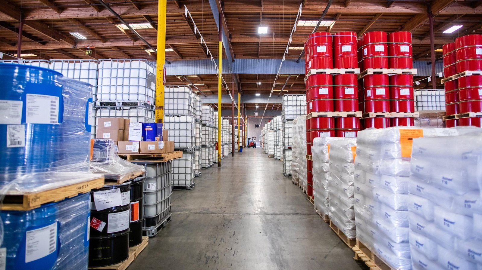 Bulk chemical drums and packaged materials in a warehouse