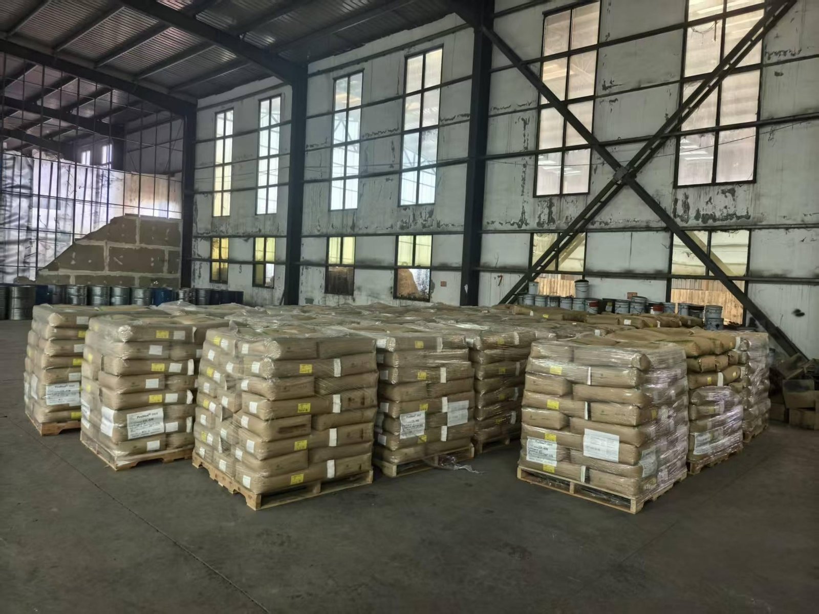 Palletised chemical products and drums staged for export shipment